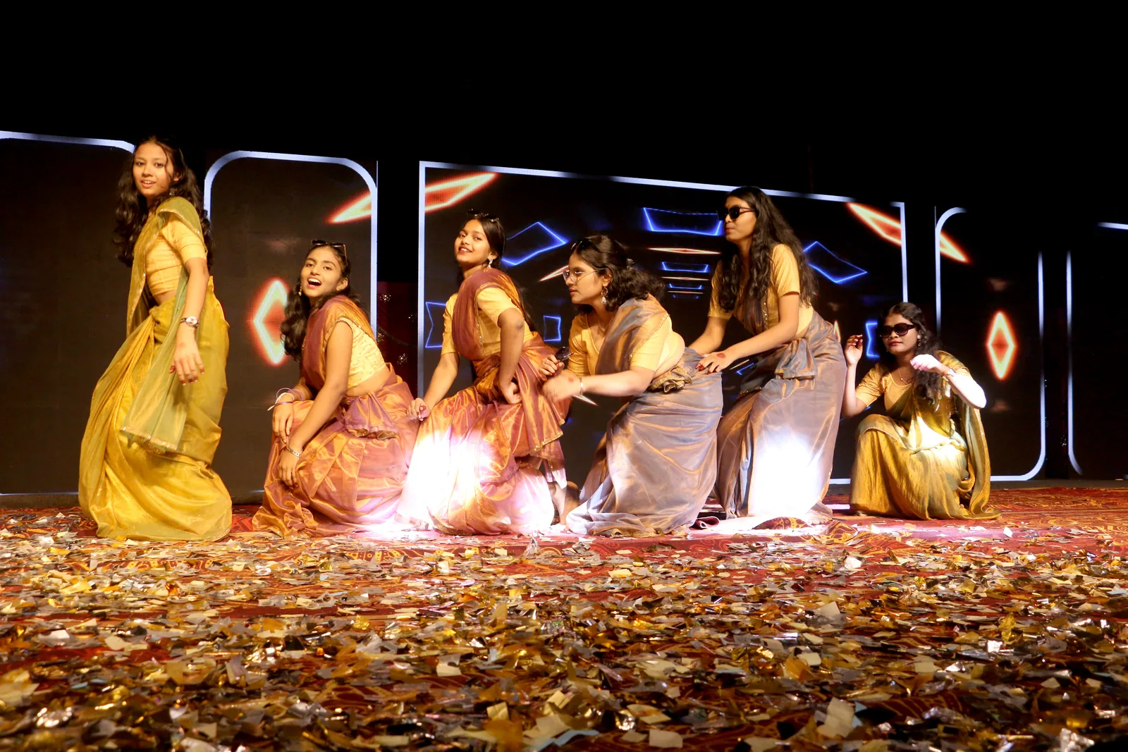 Students performing on a confetti-covered stage at Exuberanza.