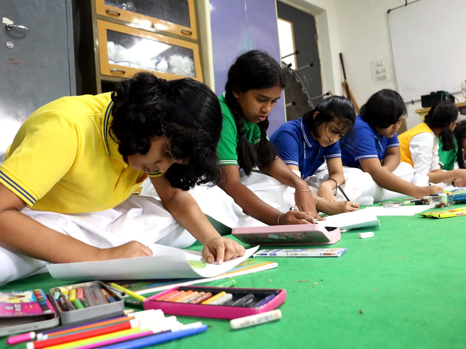 Art students painting with paints and brushes.