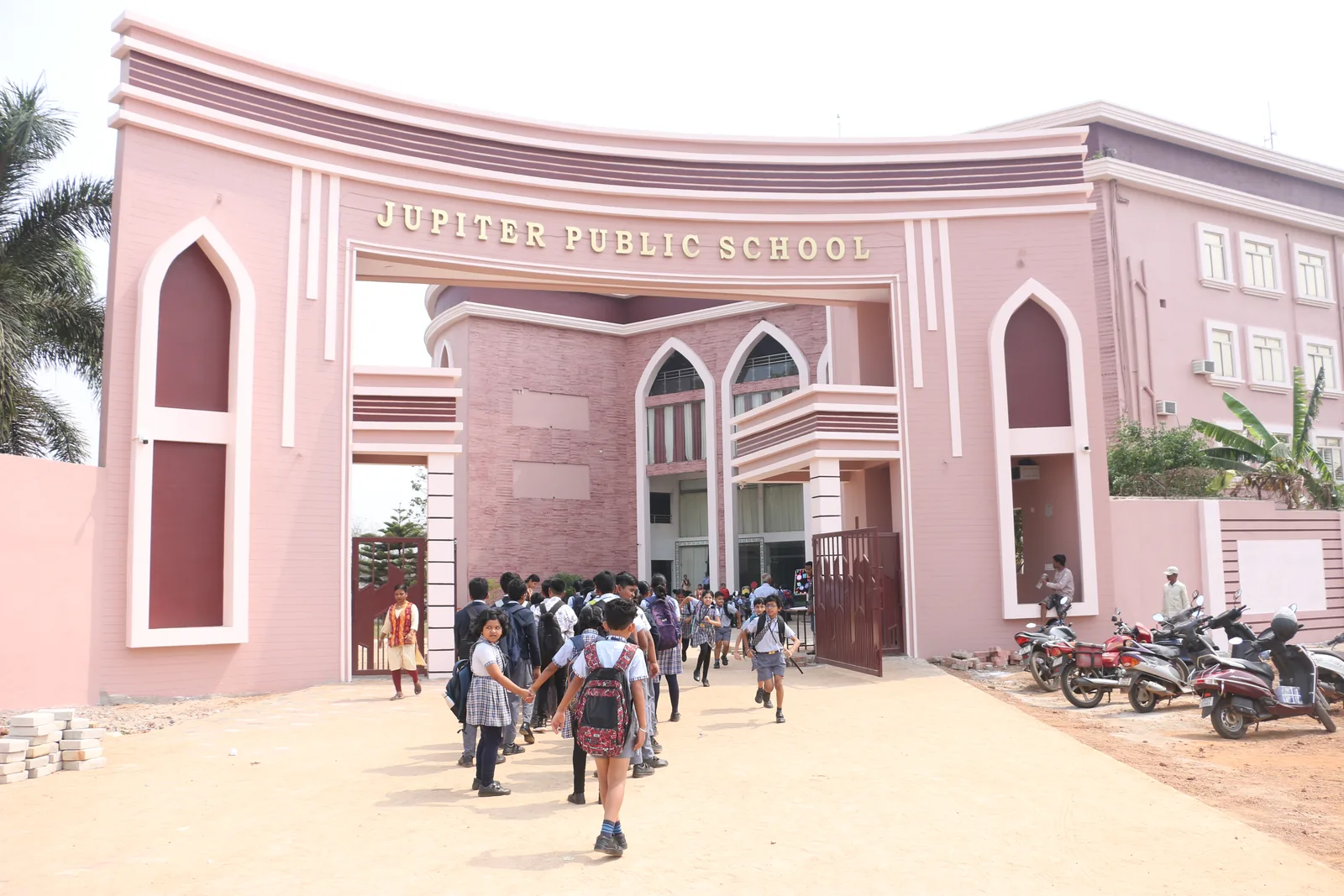 Monumental main entrance archway and academic campus of Jupiter Public School