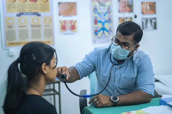 A doctor checking a student in the campus medical room.